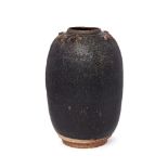 A Chinese stoneware black glazed jar, Song dynasty, of ovoid form, with studded decoration to