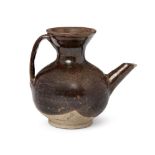 A Chinese grey stoneware ewer, Yuan dynasty, with strap handle and angular spout, the dark brown