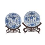 A pair of Chinese porcelain dishes, Kangxi, painted in underglaze blue with flowering lotus scrolls,