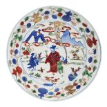 A Chinese porcelain wucai dish, Wanli mark and period, painted with a scholar and a boy being