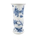 A Chinese porcelain beaker vase, Xuande mark, Kangxi period, painted in underglaze blue with three