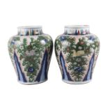 A large pair of Chinese wucai porcelain vases, Transitional period, each painted in enamels with