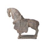 A Chinese finely modelled grey pottery figure of a caparisoned horse, Northern Wei Dynasty, standing