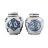 A pair of Chinese porcelain jars and covers, Kangxi, each painted in underglaze blue with quatrilobe