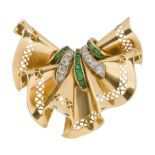 A gold, diamond and emerald clip brooch, of fan shaped ribbon design set with old-brilliant-cut