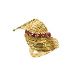 An 18ct. gold, ruby ring, the textured swirl design bezel set with five rubies, London import marks,