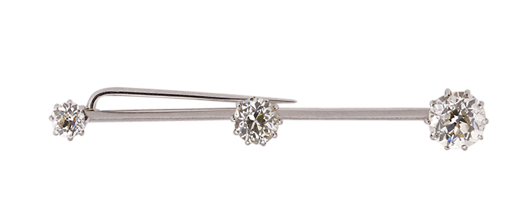 An early 20th century diamond three stone bar brooch, composed of three graduated old-brilliant-