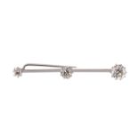 An early 20th century diamond three stone bar brooch, composed of three graduated old-brilliant-