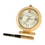 A presentation compendium travelling quartz alarm clock and pen, by Chopard, the clock with circular