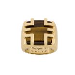 A tiger's eye 'Cage' ring, by Cartier, the rectangular bezel set with a polished tiger's eye