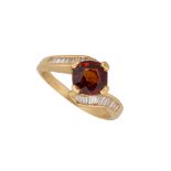 A 'Fanta' garnet and diamond ring, the central claw-set square-cut orange garnet with baguette