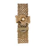 A gold, diamond jarretiere bracelet, of broad fancy mesh-link design, with single-cut diamond set