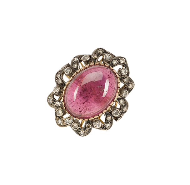 A garnet and diamond cluster ring, the single collet-set oval, cabochon garnet with circular-cut