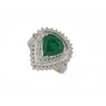 An emerald & diamond cluster ring, the claw-set central pear-shaped emerald with circular-cut