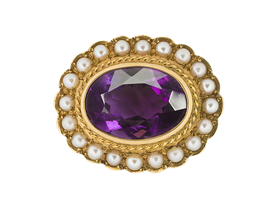 An Edwardian gold and half-pearl brooch, the collet-set oval mixed-cut amethyst in gold mount with