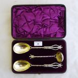 A boxed set of EPNS strawberry servers and a sugar sifter spoon