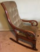 A Victorian upholstered rocking chair