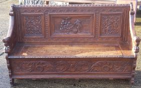 A Victorian carved oak box settle