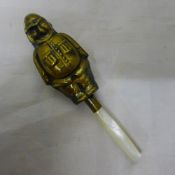 A brass rattle in the form of a policeman