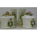 A pair of Victorian flower encrusted pots and covers and a pair of vases en-suite