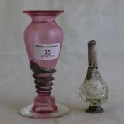 A silver mounted cranberry glass vase and a scent bottle