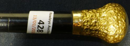 A gold plate mounted walking cane
