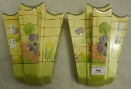 A pair of Arthur Woods wall pockets and a vase