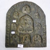 A 19th century carved wood arched plaque depicting Buddhist deities in various poses,