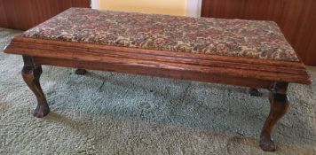 An oak framed upholstered claw and ball stool