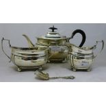 A silver three piece tea set and a caddy spoon