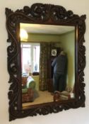 A late 19th century carved oak wall mirror