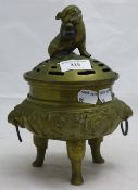 A bronze dog-of-fo topped pierced censer