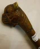 A carved dogs head walking stick,