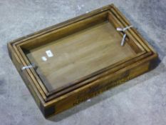 A set of three wooden trays