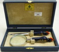 A cased letter opener and magnifying glass