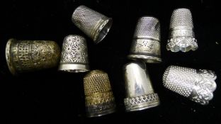 A quantity of silver thimbles,