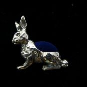 A silver pin cushion in the form of a rabbit