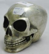 A silver plated model of a skull