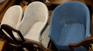 A pair of Lloyd Loom chairs and another