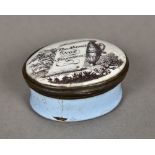 A 19th century enamelled pill box The oval hinged lid decorated with an urn in a landscape and