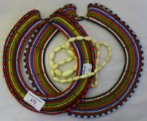 Two African glass bead chokers and a string on bone beads