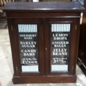 A Victorian glazed cabinet with painted advertising decoration