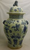 An octagonal blue and white vase and cover