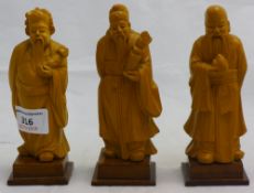 A set of three small Chinese wooden figures