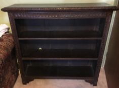 A Victorian carved oak open bookcase