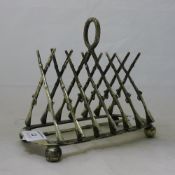 A silver plated toast rack modelled with crossed rifles