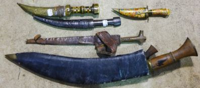 A large Kukri and four small Eastern daggers