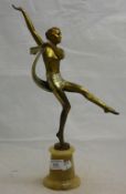 An Art Deco semi clad dancing girl on an alabaster base