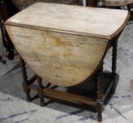 An early 20th century oak barley twist drop leaf table