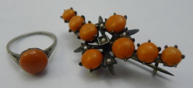 A silver and coral brooch,